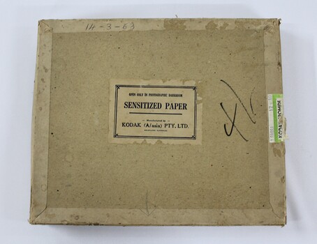 A brown rectangular cardboard box with manufacturers and production information printed on face