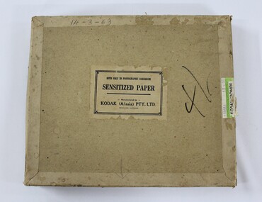 A brown rectangular cardboard box with manufacturers and production information printed on face