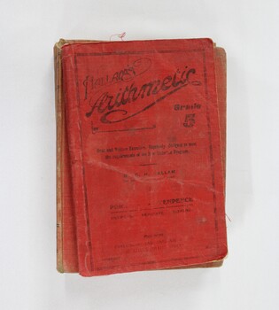 Birds eye view of red cloth bound school books `