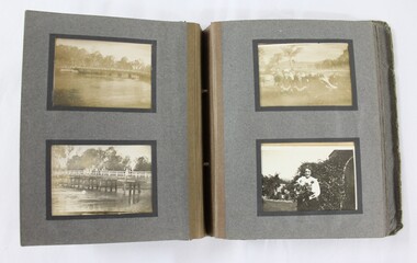 Open photograph album showing a picture of a bridge over a river, and of a woman holding flowers. 