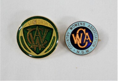 Two small round badges, one with green and yellow design, one with blue and orange design