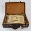 A brown vinyl suitcase containing song books, periodicals and magazines  