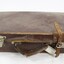 A closed brown vinyl suitcase 