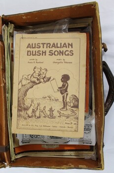 A brown vinyl suitcase containing song books, periodicals and magazines  