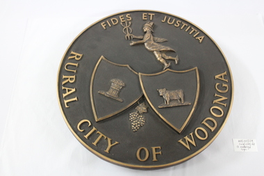 A metal circular plate representing the Rural City of Wodonga.