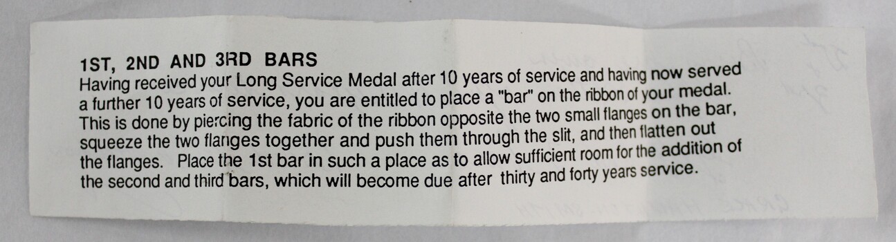A block of black text on white paper describing the correct wear of Red Cross long service medals