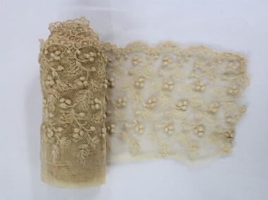 Rolled cream coloured lace with a floral design 