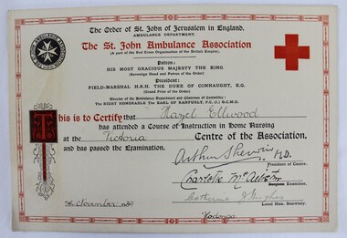 A printed certificate with black text and red bordering, and hand written inscriptions.
