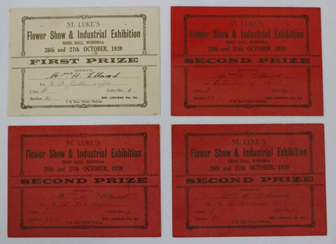 Three red second prize award certificates, and one cream coloured first prize award certificate