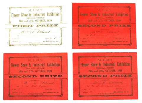 Three red second prize award certificates, and one cream coloured first prize award certificate