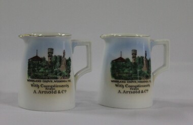 A pair of china jugs with a water colour representation of Woodland Grove, Wodonga including the Soldier Memoria, Rotunda and Water Tower. 