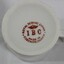 Maker's mark for IBC Royal Scenic China. Orange circular text with crown in centre and initials IBC