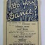 A small paper booklet printed featuring a picture of a crowded ball room, and a list of song titles