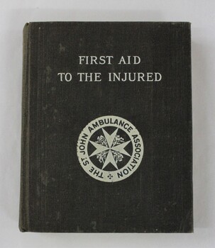 A small black cloth bound book with title and logo printed in white 