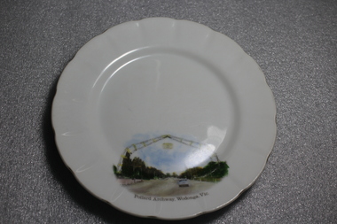 Fine china plate, white with a hand- painted image of the Pollard Archway in Wodonga, Victoria in the bottom third of the plate. 