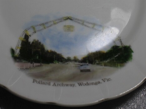 Close up photo of the hand-painted image of the Pollard Archway on lower portion of plate