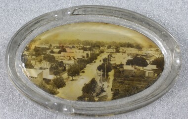 An oval shaped glass ashtray, incorporating a sepia print image of High Street, Wodonga, Victoria