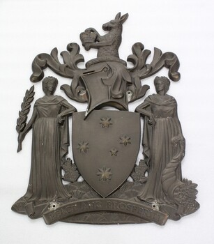 Metal shield for the Victorian State Government offices. The kangaroo at the top holds a crown. The shield also features the Southern Cross