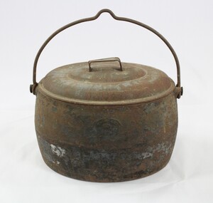 A metal camp oven with handle 