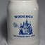 A white china beer stein bearing the blue logo of the Wodonga 1979 Oktoberfest