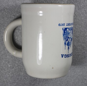Side view of beer stein showing part of logo and handle