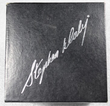 Base of the box showing the signature of the manufacturer Stephen Daly embossed in silver script.