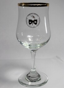 A wine glass with gold rim bearing the logo of the Rural City of Wodonga