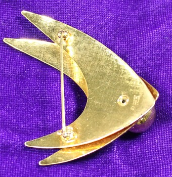 Back of gold-toned metal brooch from the Sarah Coventry Pty. Ltd. with pin clip