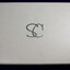 Top of white jewellery box inscribed with intertwined silver letters SC