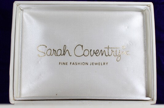 Inside of the jewellery box lid showing the logo and trademark of Sarah Coventry Inc.