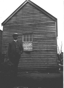 An image of a smartly dressed man wearing a straw boater hat.