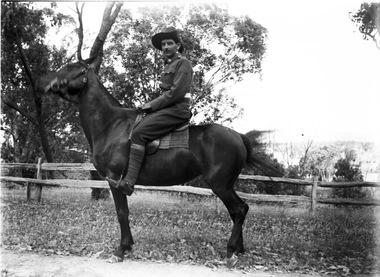 Jim O'Brien mounted on a horse and wearing military uniform.