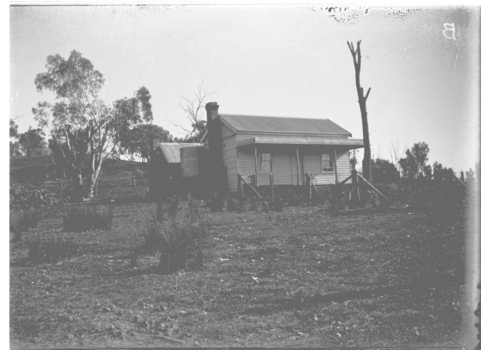 A small wooden house built in West Wodonga. An open area cleared around it.