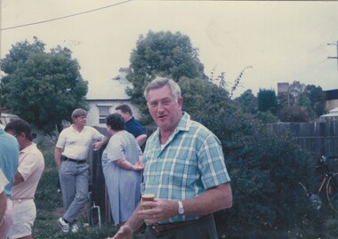 Photo of John Wortmann and a group of people in the background.