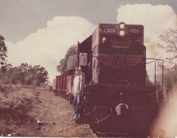 Fireman Ian Sandford on step of locomotive