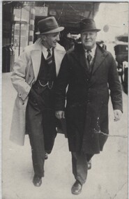 Jack Dwyer and Harry Dwyer walking along station platform.