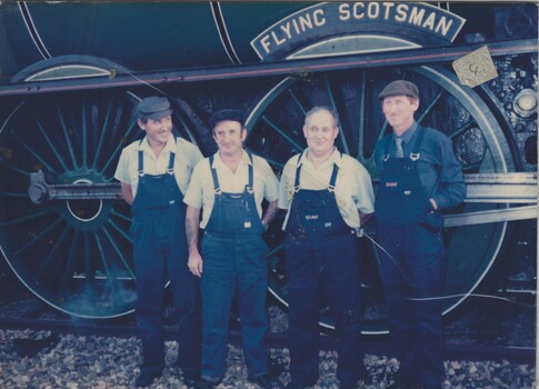 Four railway crew  standing beside "The Flying Scotsman" Locomotive