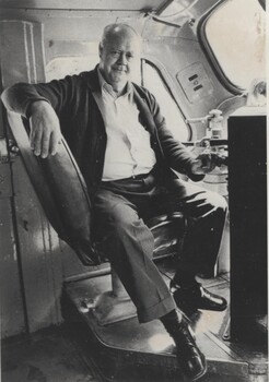 Driver Bill Welsh seated inside cabin of locomotive.