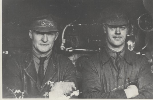 Driver Ray Murphy and Fireman Bill Welsh in front of locomotive.