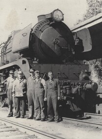 5 members of the railway crew standing in front of Locomotive 752