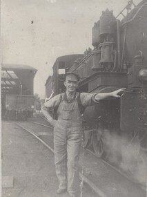George Lynch standing beside a DD locomotive.