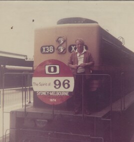 Driver George Judge standing on front of Locomotive X38