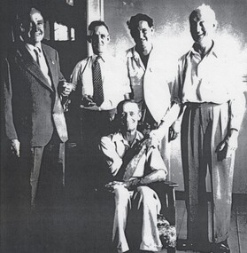 5 men at the retirement function of Jack Schmidt who is seated.