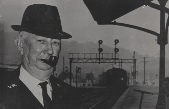  Guard H Fraser's to the left of the image with a locomotive in the background.