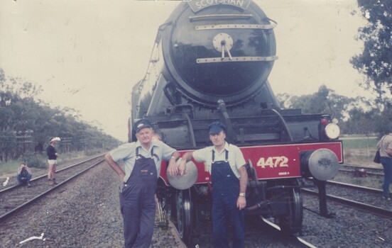 Driver Len Gregson and Fireman Noel Strauss leaning against the front of Locomotive 4472