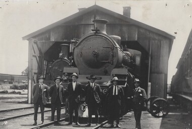 A group of 6 men standing in front of a locomotive in Wodonga