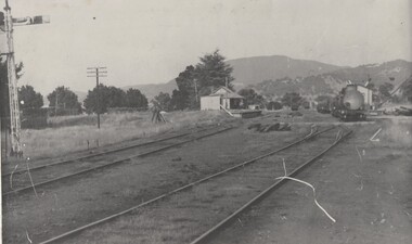 Cudgewa railway station with locomotive and storage sheds on the right.