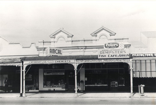 Shops in High Street East, Wodonga J. McSwiney & Co Chemist, Dempster’s Café and Pilkington’s Shoes