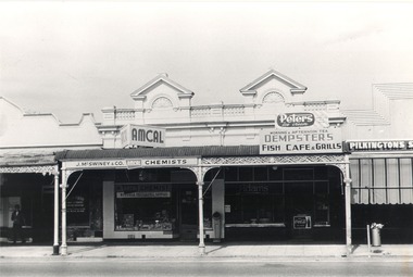 Shops in High Street East, Wodonga J. McSwiney & Co Chemist, Dempster’s Café and Pilkington’s Shoes