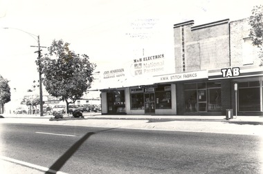 Row of businesses -  Holloways Motors,  John Henderson & Associates, M & H Electrics, Kwik Stitch, T.A.B